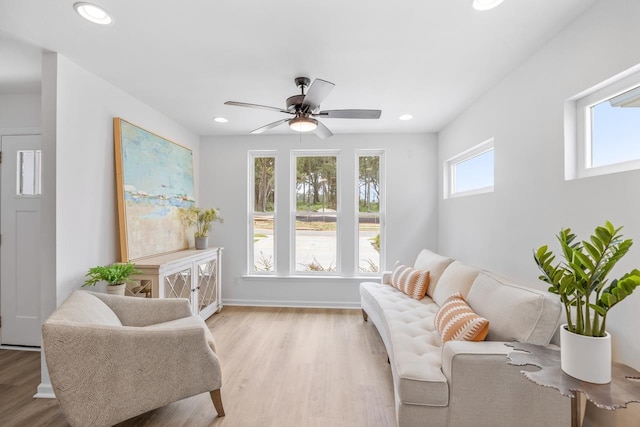 living area featuring ceiling fan and light hardwood / wood-style floors