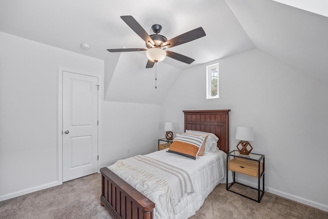 bedroom with ceiling fan, light carpet, and vaulted ceiling