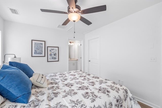 bedroom featuring hardwood / wood-style floors, ceiling fan, and connected bathroom