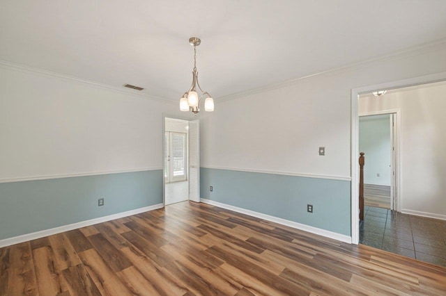 2903 Whirlaway Trl, Tallahassee, FL 32309 - unfurnished room with ornamental molding, wood finished floors, baseboards, and a chandelier