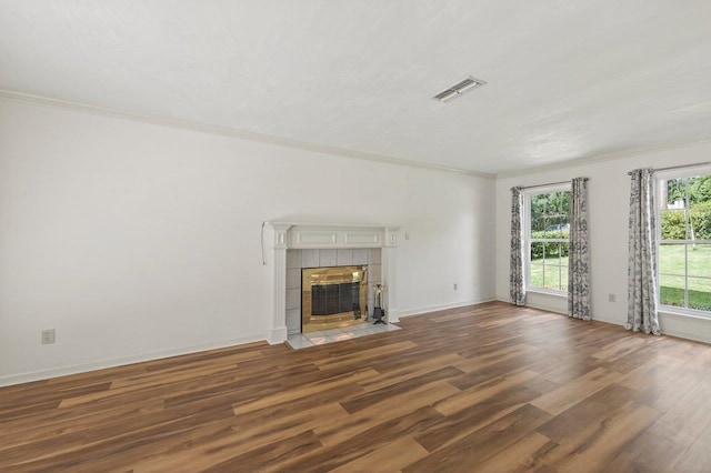 2903 Whirlaway Trl, Tallahassee, FL 32309 - unfurnished living room featuring wood finished floors, ornamental molding, a tile fireplace, and baseboards
