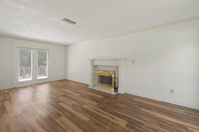 2903 Whirlaway Trl, Tallahassee, FL 32309 - unfurnished living room featuring wood finished floors, a tile fireplace, french doors, ornamental molding, and baseboards