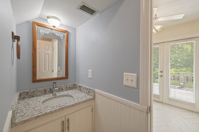 2903 Whirlaway Trl, Tallahassee, FL 32309 - bathroom with vanity, a wainscoted wall, marble look tile flooring, ceiling fan, and vaulted ceiling