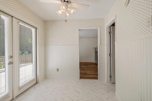 2903 Whirlaway Trl, Tallahassee, FL 32309 - hallway with wainscoting and light marble finish flooring