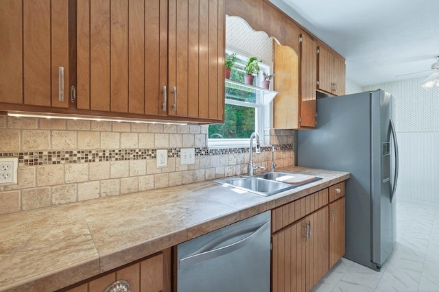 2903 Whirlaway Trl, Tallahassee, FL 32309 - kitchen featuring stainless steel appliances, a sink, light marble finish floors, and light countertops