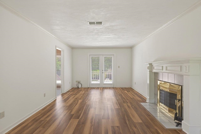 2903 Whirlaway Trl, Tallahassee, FL 32309 - unfurnished living room featuring a tiled fireplace, wood finished floors, crown molding, french doors, and baseboards