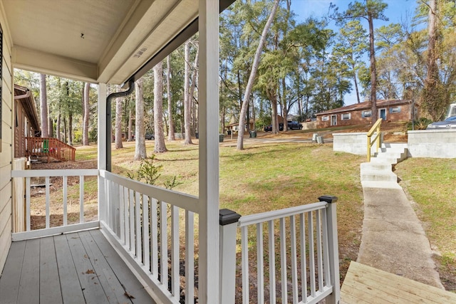 deck featuring a porch and a lawn