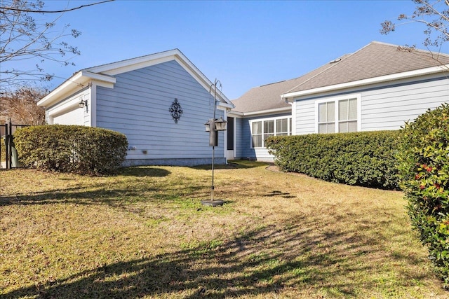 back of house with a lawn