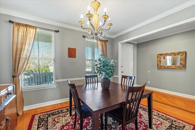 dining room with hardwood / wood-style flooring, a notable chandelier, and ornamental molding