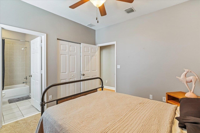 bedroom featuring ceiling fan, connected bathroom, a closet, and light tile patterned flooring