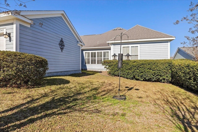 back of house with a lawn