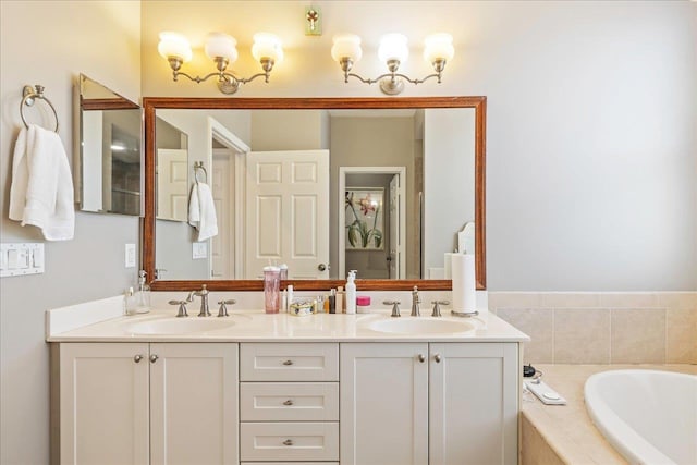 bathroom featuring a relaxing tiled tub and vanity