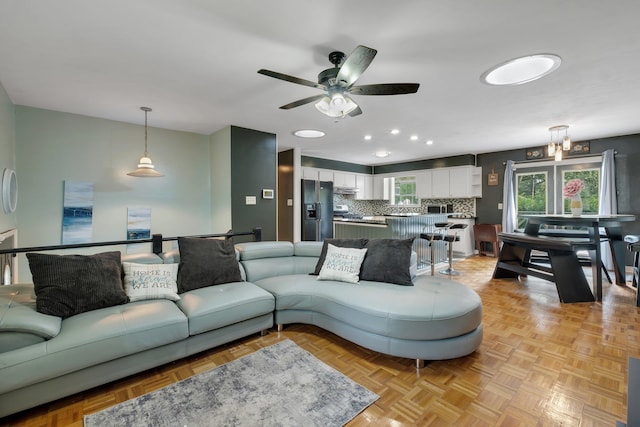 living room featuring light parquet floors and ceiling fan