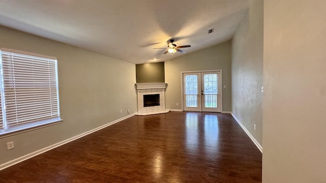 4417 Siesta Ct, Tallahassee, FL 32309 - unfurnished living room with ceiling fan, vaulted ceiling, dark wood-style flooring, a tile fireplace, and baseboards