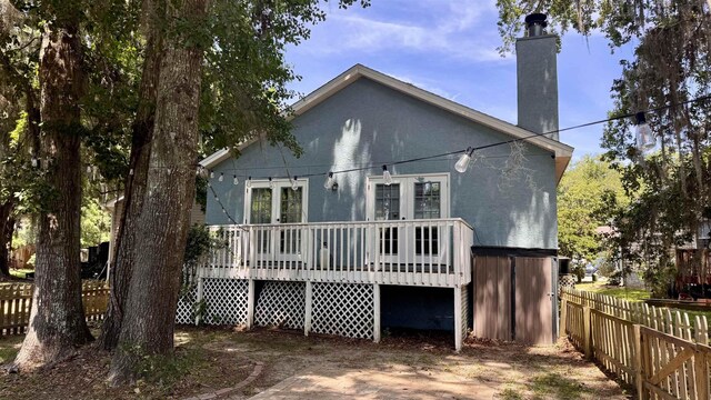 4417 Siesta Ct, Tallahassee, FL 32309 - rear view of house featuring a wooden deck, french doors, and a chimney