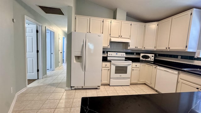 4417 Siesta Ct, Tallahassee, FL 32309 - kitchen featuring white appliances, under cabinet range hood, light tile patterned floors, dark countertops, and vaulted ceiling