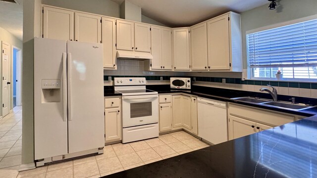 4417 Siesta Ct, Tallahassee, FL 32309 - kitchen featuring white appliances, a sink, under cabinet range hood, decorative backsplash, and lofted ceiling