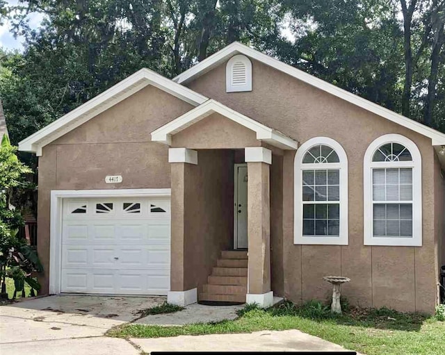 4417 Siesta Ct, Tallahassee, FL 32309 - ranch-style house with a garage, stucco siding, and driveway