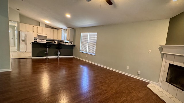 4417 Siesta Ct, Tallahassee, FL 32309 - living room featuring lofted ceiling, ceiling fan, wood finished floors, baseboards, and a fireplace