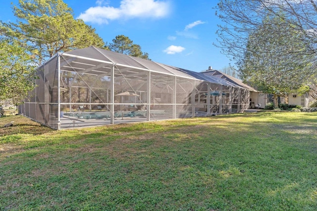 view of yard with glass enclosure and an outdoor pool