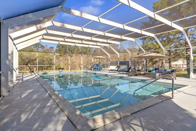 pool with a patio area, glass enclosure, and an outdoor hangout area