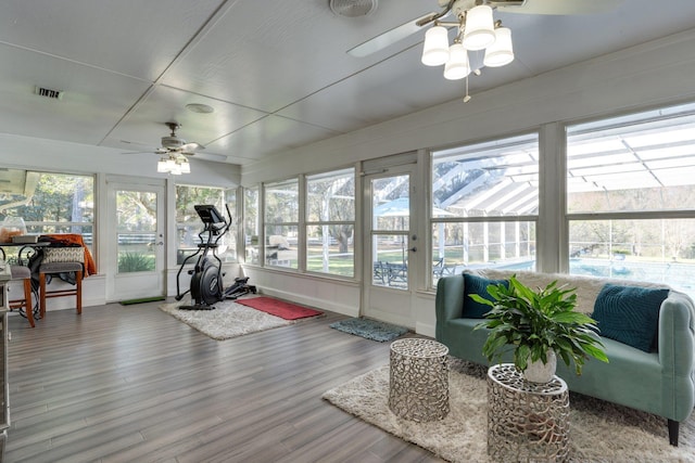 exercise area with a ceiling fan, wood finished floors, and visible vents