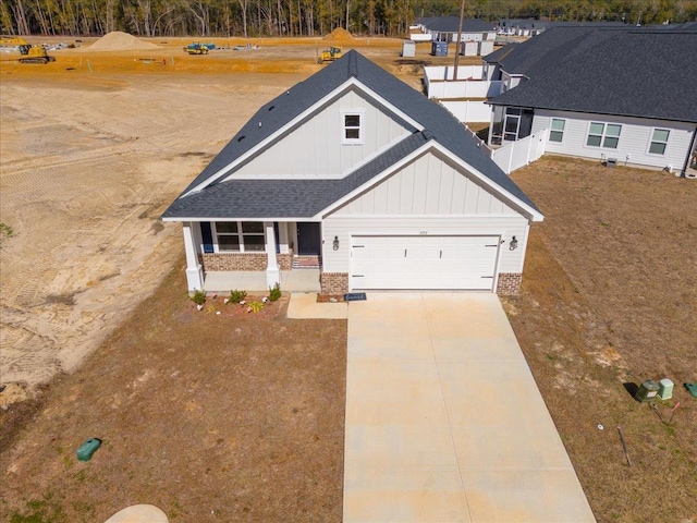 craftsman inspired home featuring a garage and covered porch