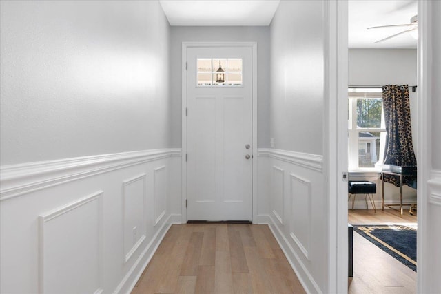 doorway featuring ceiling fan and light wood-type flooring