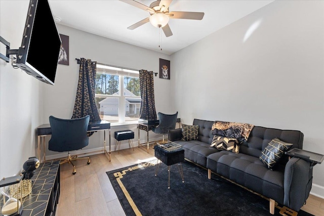 living room featuring hardwood / wood-style flooring and ceiling fan