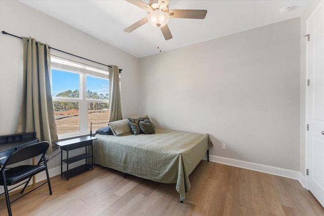 bedroom with light hardwood / wood-style floors and ceiling fan