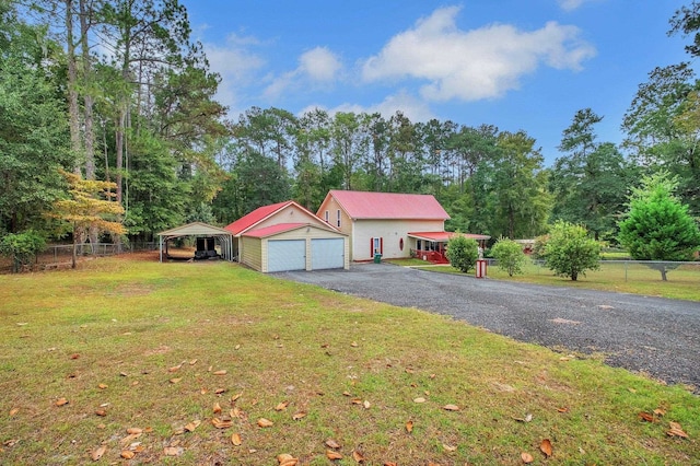 ranch-style house featuring a front yard, a carport, and a garage