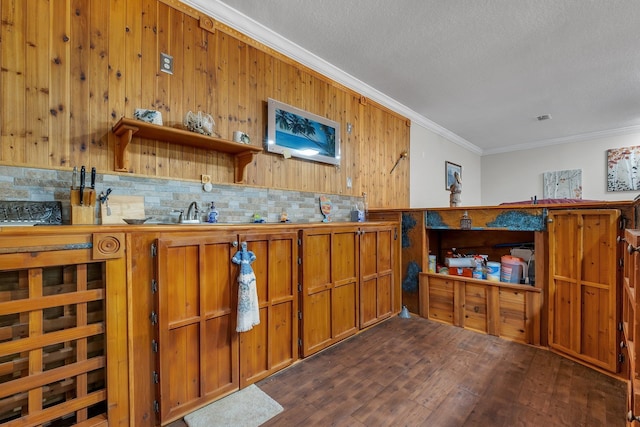 2875 Cooks Landing Rd, Quincy, FL 32351 - bar area featuring crown molding, dark wood-type flooring, decorative backsplash, a textured ceiling, and wood walls
