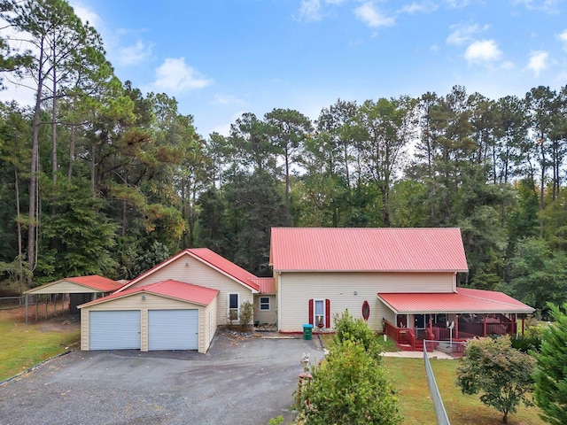 2875 Cooks Landing Rd, Quincy, FL 32351 - view of front of property featuring metal roof, an outdoor structure, a garage, and a front lawn
