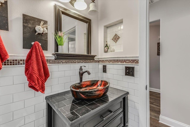 bathroom featuring vanity, wood-type flooring, and tile walls