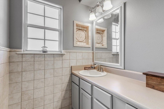 bathroom with vanity and tile walls