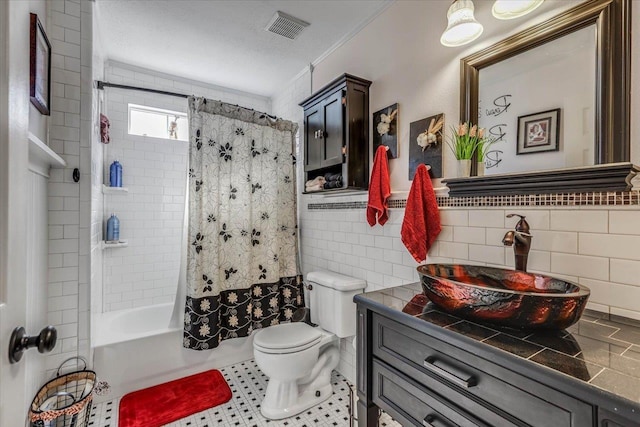 full bathroom with vanity, toilet, shower / tub combo, and tile walls