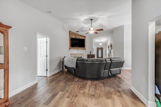 living room with wood-type flooring, vaulted ceiling, and ceiling fan