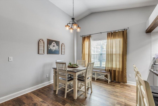 dining room with lofted ceiling, hardwood / wood-style floors, and an inviting chandelier