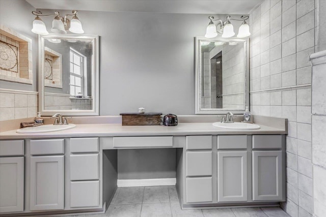 bathroom with tile patterned flooring, vanity, and tile walls