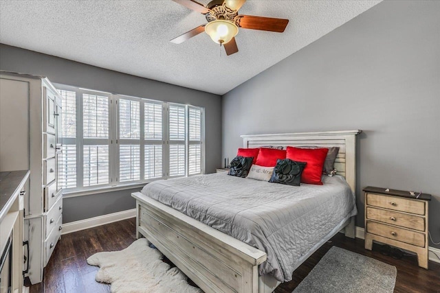 bedroom with dark hardwood / wood-style flooring, vaulted ceiling, and a textured ceiling