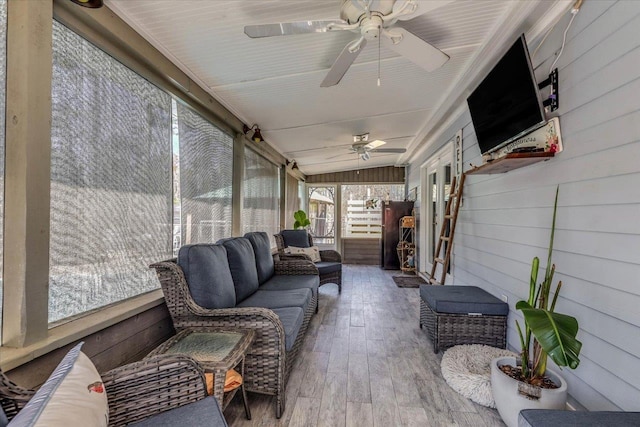 sunroom featuring lofted ceiling and ceiling fan