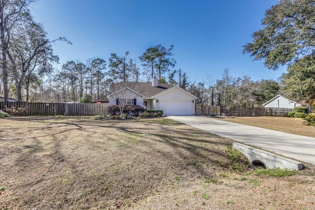 view of front of property featuring a garage and a front yard