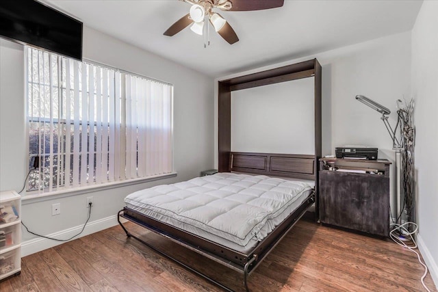 bedroom featuring dark hardwood / wood-style flooring and ceiling fan