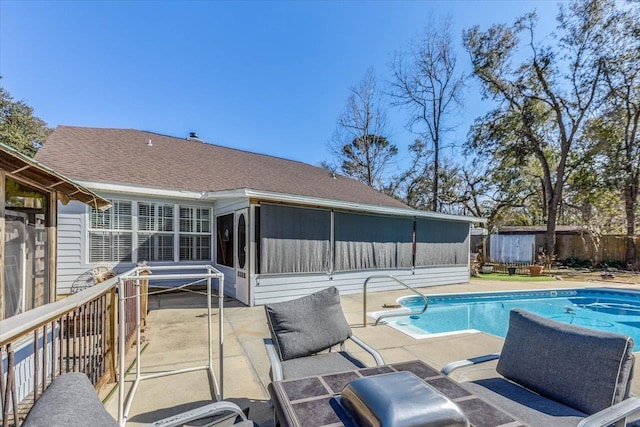 view of pool with a patio and a sunroom