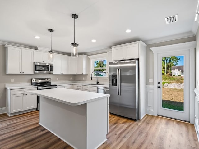 kitchen featuring white cabinets, a healthy amount of sunlight, and appliances with stainless steel finishes