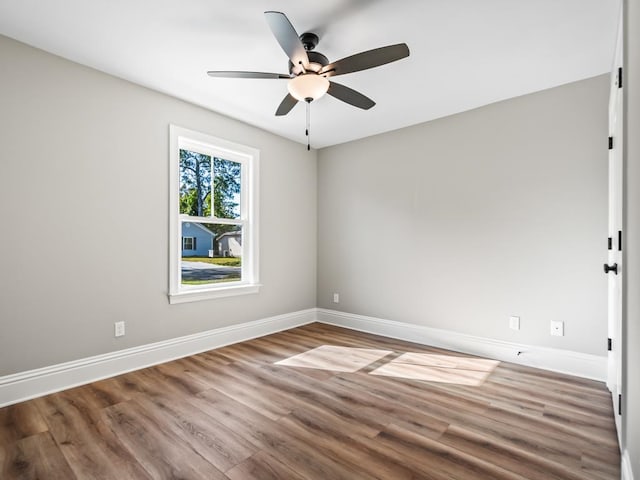 spare room featuring hardwood / wood-style flooring and ceiling fan