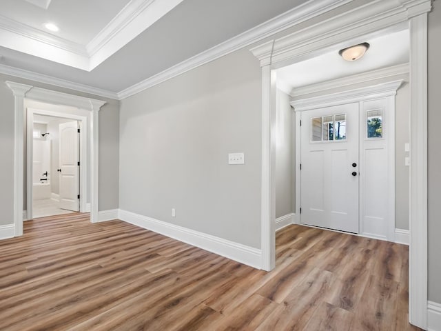 foyer entrance featuring hardwood / wood-style flooring and crown molding