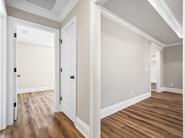 hall with ornamental molding and hardwood / wood-style flooring