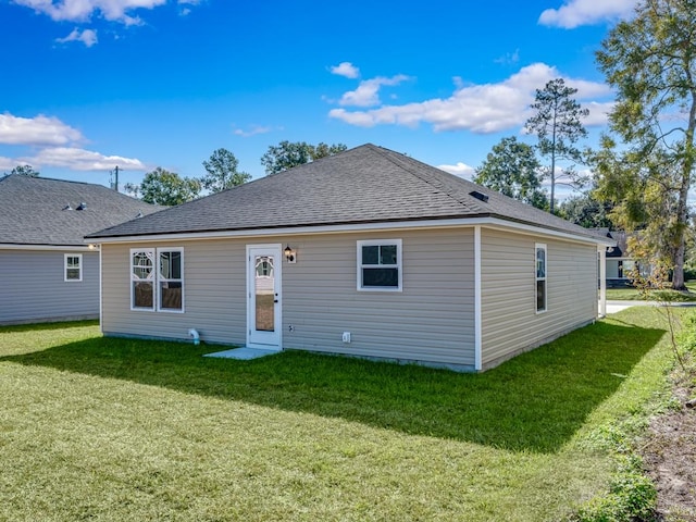 back of house featuring a lawn