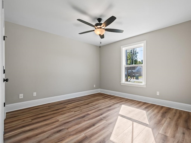 spare room with wood-type flooring and ceiling fan